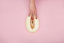 person holding a sliced melon