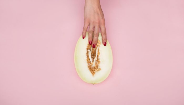 person holding a sliced melon